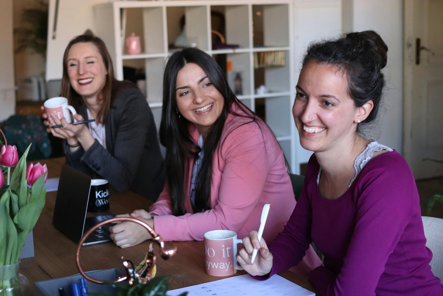 Three women learning and laughing together